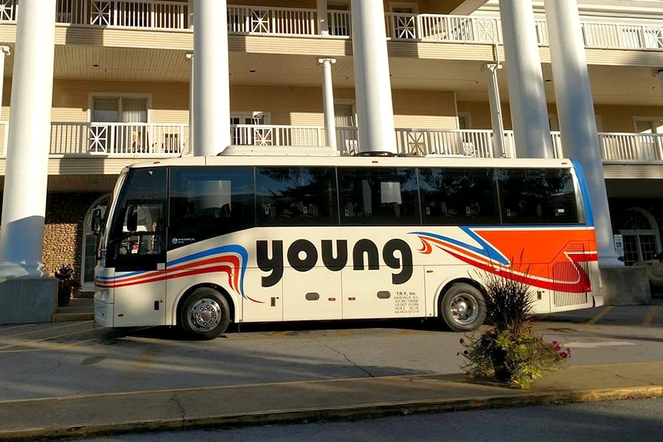 Young Transportation 36-passenger motorcoach at a hotel entrance