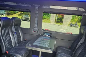 Young Transportation luxury van seating with a fold-out table between rows