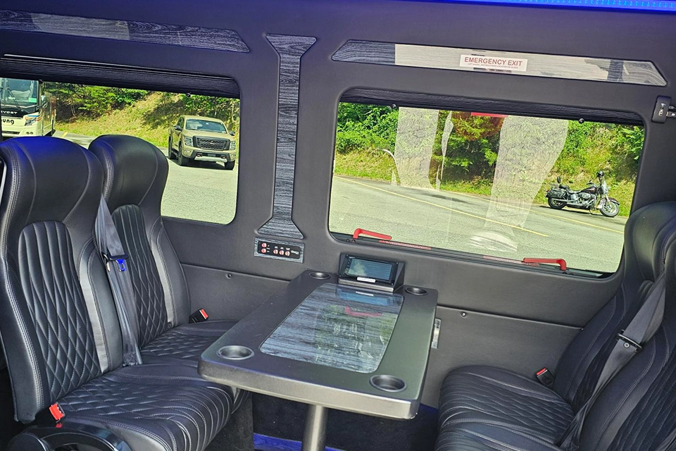 Young Transportation luxury van seating with a fold-out table between rows